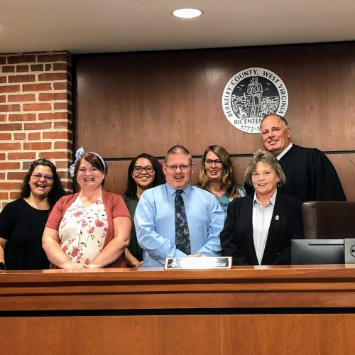 The Honorable Judge Steven Redding of the Twenty-Third Judicial Circuit Court (right) swears in six new CASA-EP volunteers to provide a voice for vulnerable children in Morgan, Berkeley, and Jefferson counties. Appearing left to right, back row: Lorie Mullan, Allison Davenport, Dawn Bussard, Judge Redding. In front: Misty Jett, Jimmy Oates, Lori Kelly.